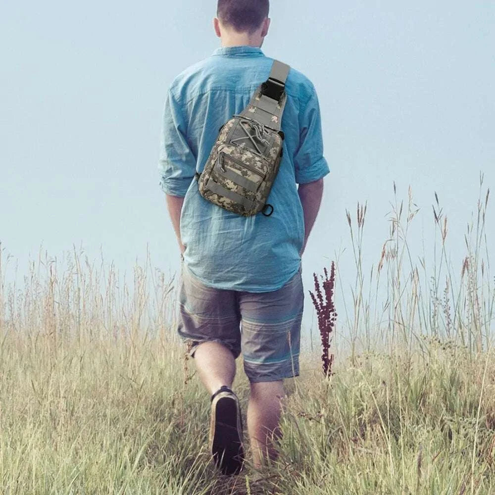 Military Tactical Shoulder Bag in jungle camo, worn by a person walking through a field.