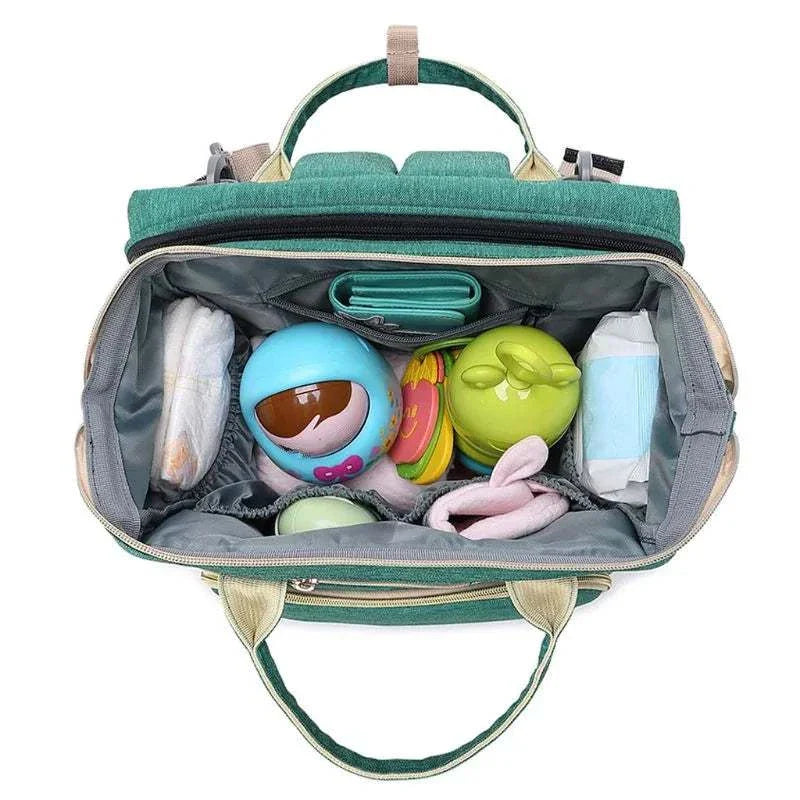 Unisex Baby Nappy Changing Bag with large capacity and folding crib feature, organized interior with essentials, perfect for travel.