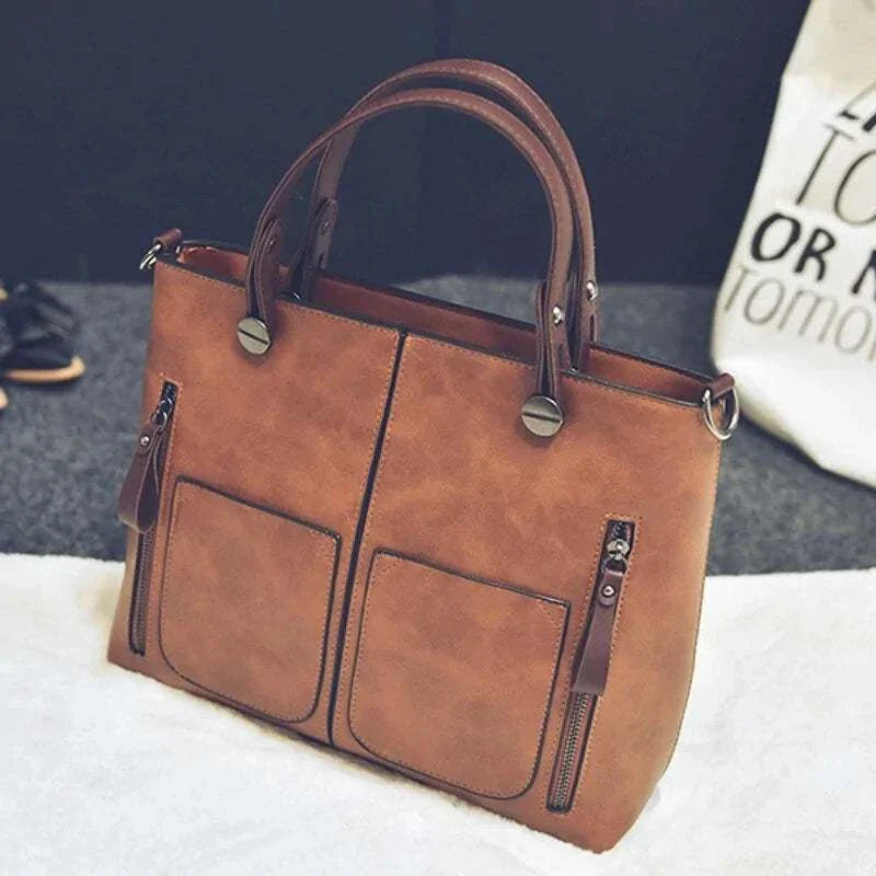 Wax oil leather bag with double handles and front pockets, handcrafted elegance in rich brown shade.