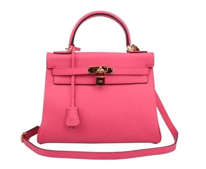 Pink luxury handbag with top handle and crossbody strap, featuring gold hardware, known as The Los Angeles Bag.