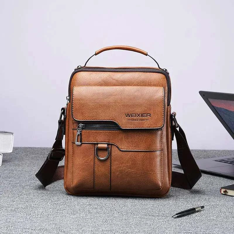 Men Crossbody Bag in brown leather with multiple compartments and adjustable strap, sleek design.