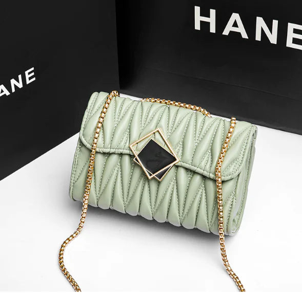 Elegant Fashionista Crossbody Bag with chic quilted design and gold chain strap in soft green, ideal for everyday style and functionality.