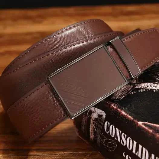 Men's leather belt with sleek metal buckle on a wooden surface.