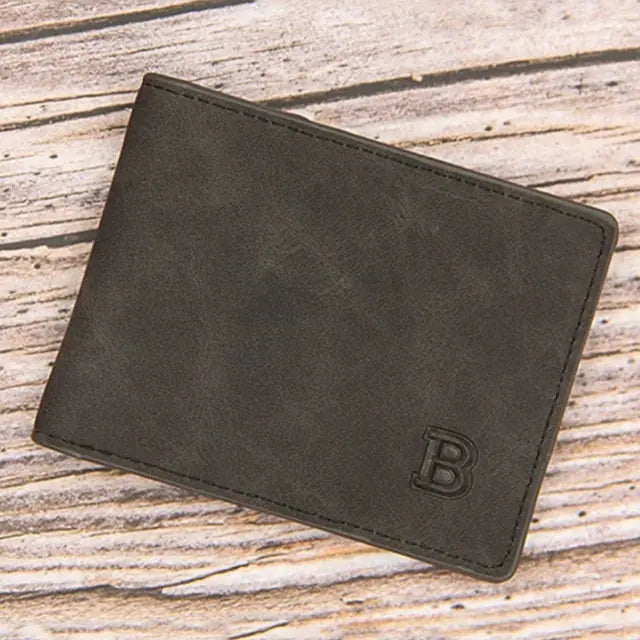 Men's wallet with coin bag in solid color and minimalist design on wooden surface.